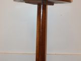 a small wooden table with a wooden base on the floor