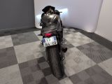 a motorcycle that is parked in a room with a checkered floor