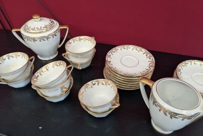 a table with a bunch of cups and saucers on it