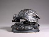 a bronze statue of a pheasant on a marble base