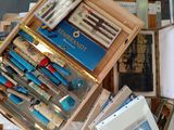 a wooden box filled with different types of pens and pencils