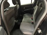 the back seats of a car with a dog sitting in the passenger seat
