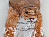 a stuffed animal in a plastic bag on a table