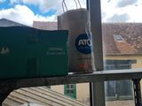 a bag of toilet paper sitting on a window sill next to a box of toilet paper and a bag of toilet paper on a window sill