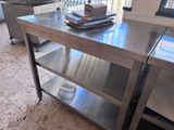 a stainless steel table with a book on top of it