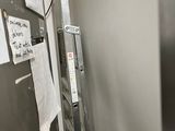 a ladder that is leaning against a wall with papers on it