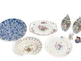 many different types of plates and bowls on the table