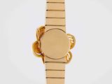 a close up of a gold wrist watch with a white background