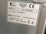 a label on the back of a machine that is sitting on a table