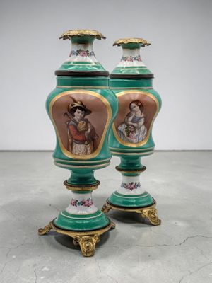 pair of green and gold vases with figures painted on them
