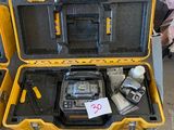a yellow case with tools in it sitting on the ground