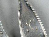 three spoons and two spoons on a table