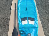 a blue surfboard sitting on top of a cardboard box
