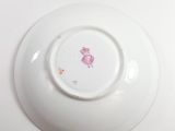 a white plate with a pink design on it