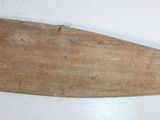 a wooden paddle that is sitting on a table