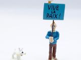 figurine of a man holding a sign with a dog nearby