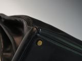a close up of a black purse on a table