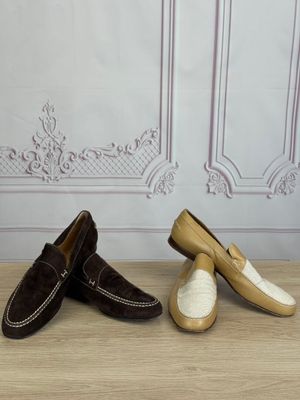 three pairs of shoes are lined up on a wooden floor