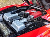a red car with a red engine and a black hood