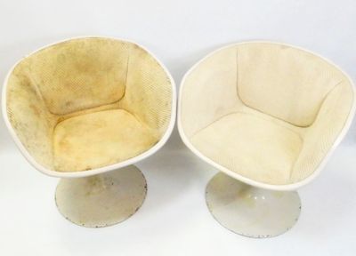 pair of mid - century tulip chairs with upholstered cushions