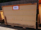 a dumpster that is sitting in front of a fence