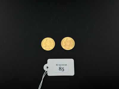 a close up of two gold coins on a black surface