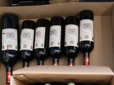 many bottles of wine in a box on the table
