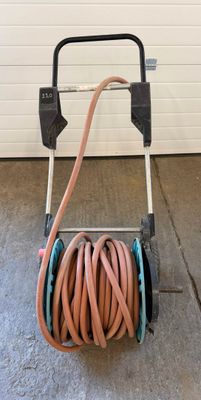 a hose that is attached to a cart with a hose