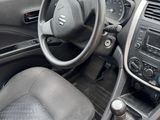 the interior of a small car with a steering wheel and dashboard