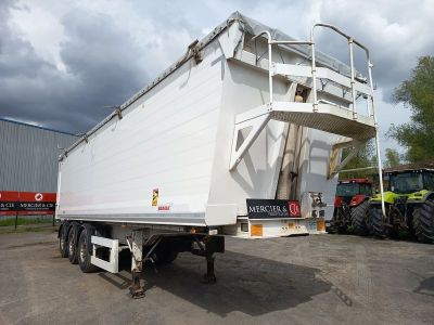 un gros camion blanc garé sur un parking