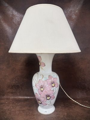 a lamp that is sitting on a table with a white shade