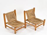 pair of chairs made of bamboo and wicker on white background