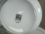 a person holding a white plate with a logo on it