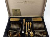 a suitcase with a set of silverware in it