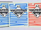 three books are lined up in a row on a white surface