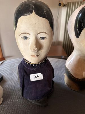 two figurines of a woman with a name tag on them
