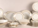 many different types of plates and bowls on the table