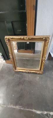 a mirror sitting on the floor next to a door