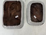 two pans of brownies sitting on a table