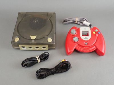 a video game console with a game controller next to it