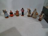 sept figurines représentant des personnes vêtues de costumes traditionnels