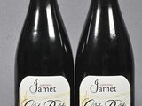 two bottles of wine sitting next to each other on a table