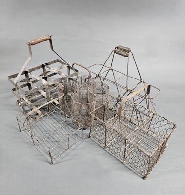 several metal baskets with handles and handles are stacked on top of each other