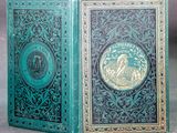 an old book with a green cover sitting on top of a table