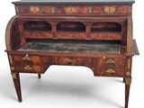 an antique writing desk with a marble top and drawers