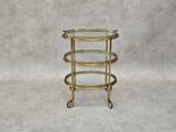an image of a three tiered glass and brass bar cart