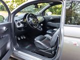 the interior of a car with the door open and the driver ' s seat up