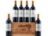 four bottles of red wine in a wooden crate