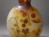 a vase with a design on it sitting on a table