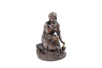 statue of a woman sitting on a rock with a bottle in her hand